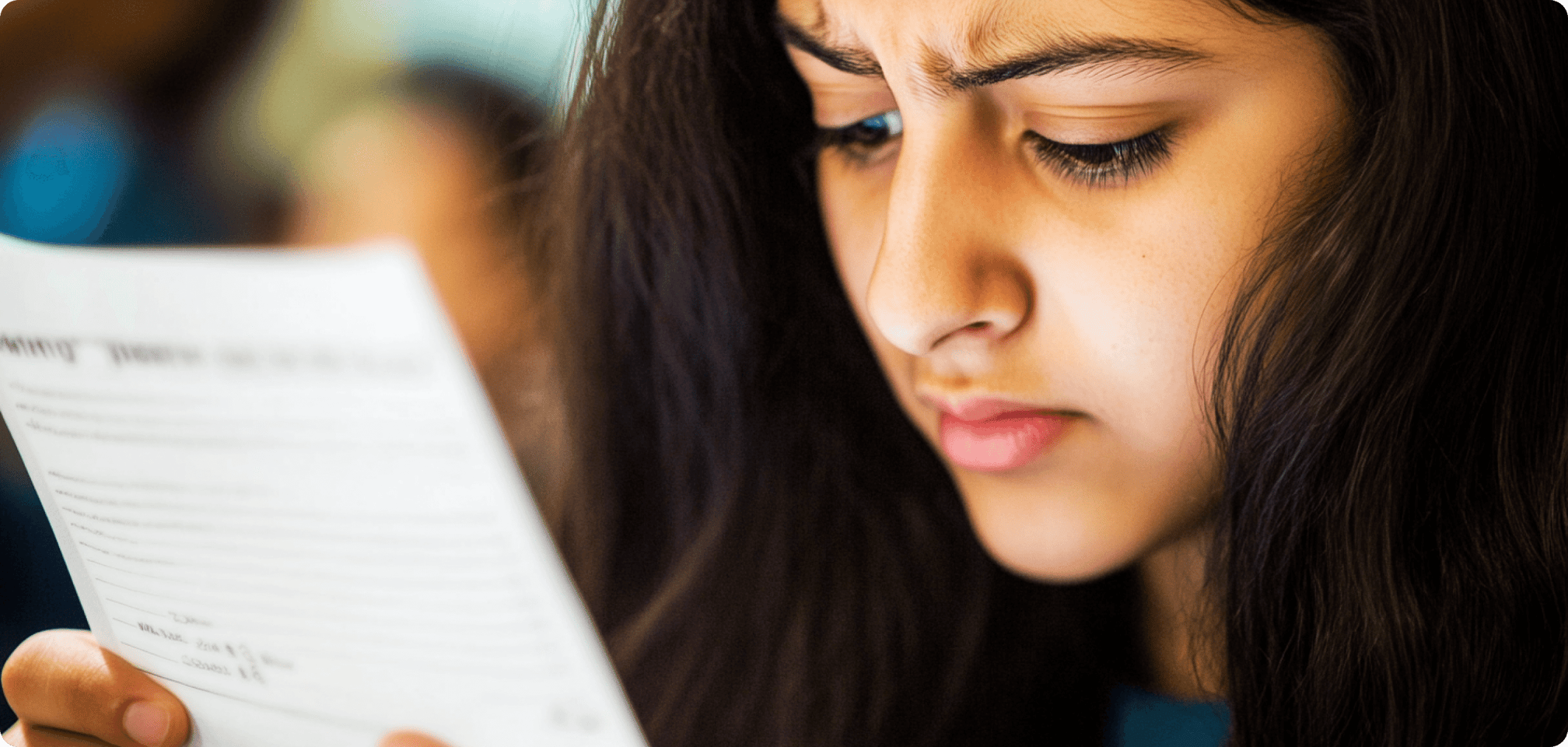 a stressed student looking at a report card