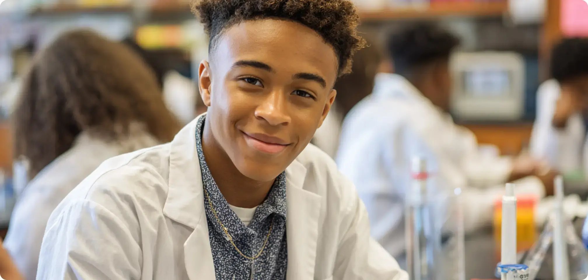 a student wearing a lab coat in a lab