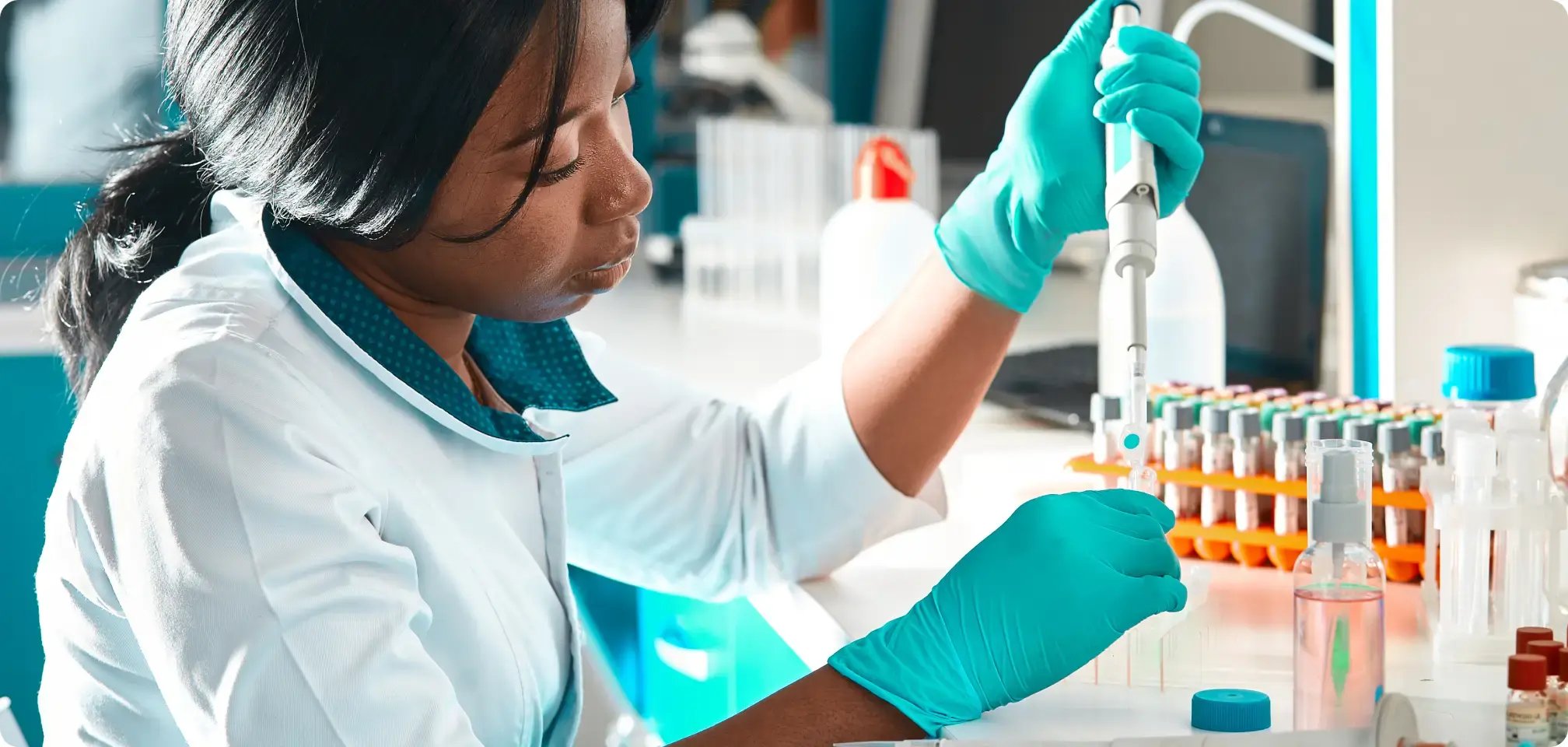 a young adult working in a lab coat