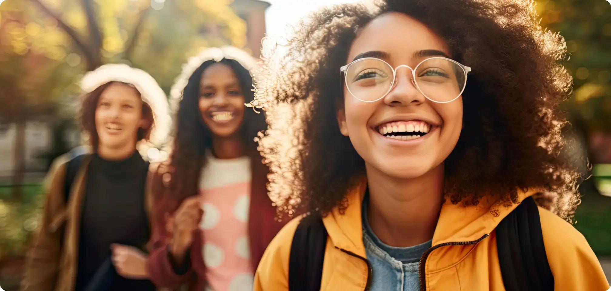 a group of students smiling together with backpacks on at school