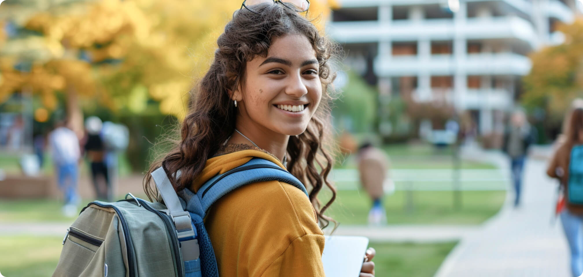 a student wearing a backpack on a college campus