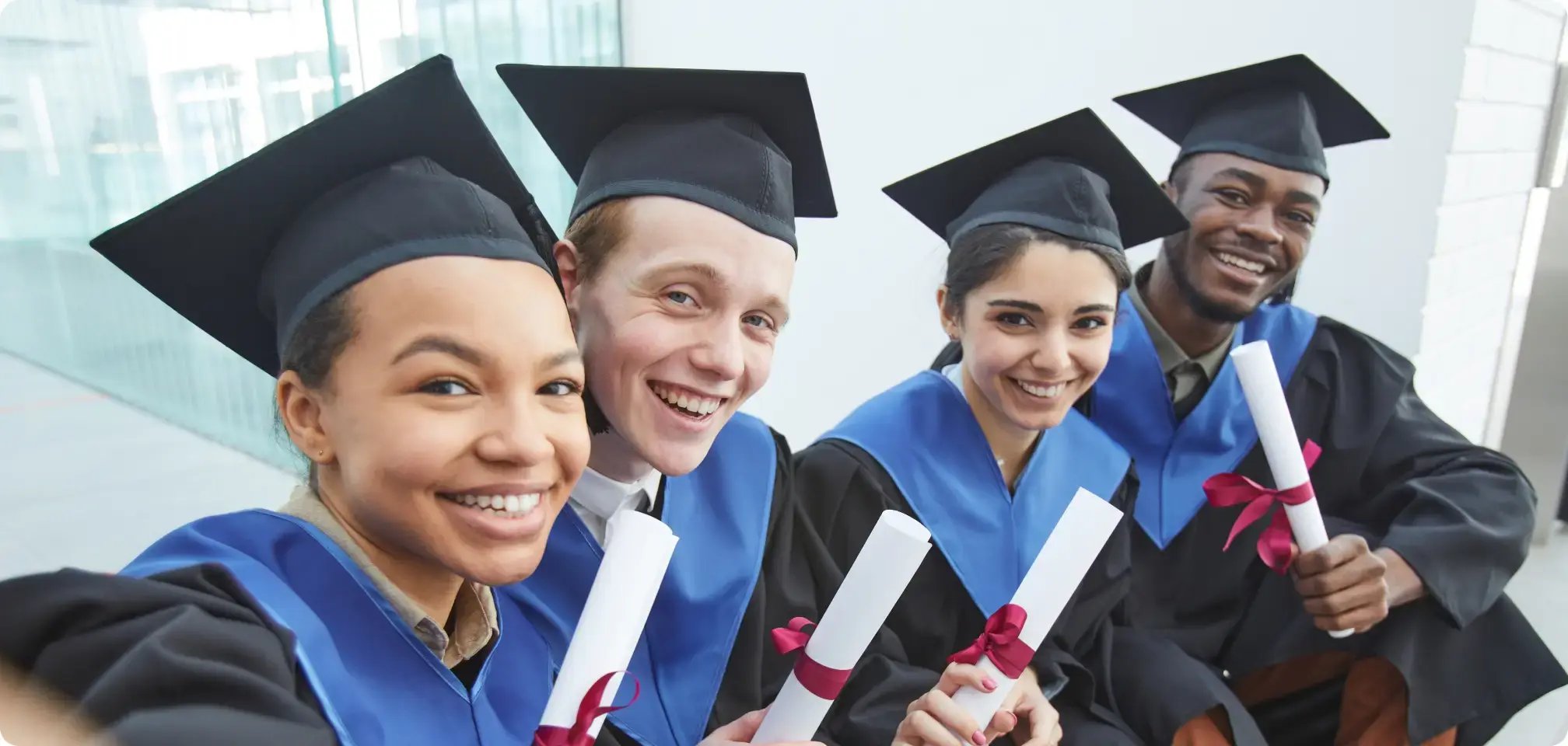 students smiling with diploma