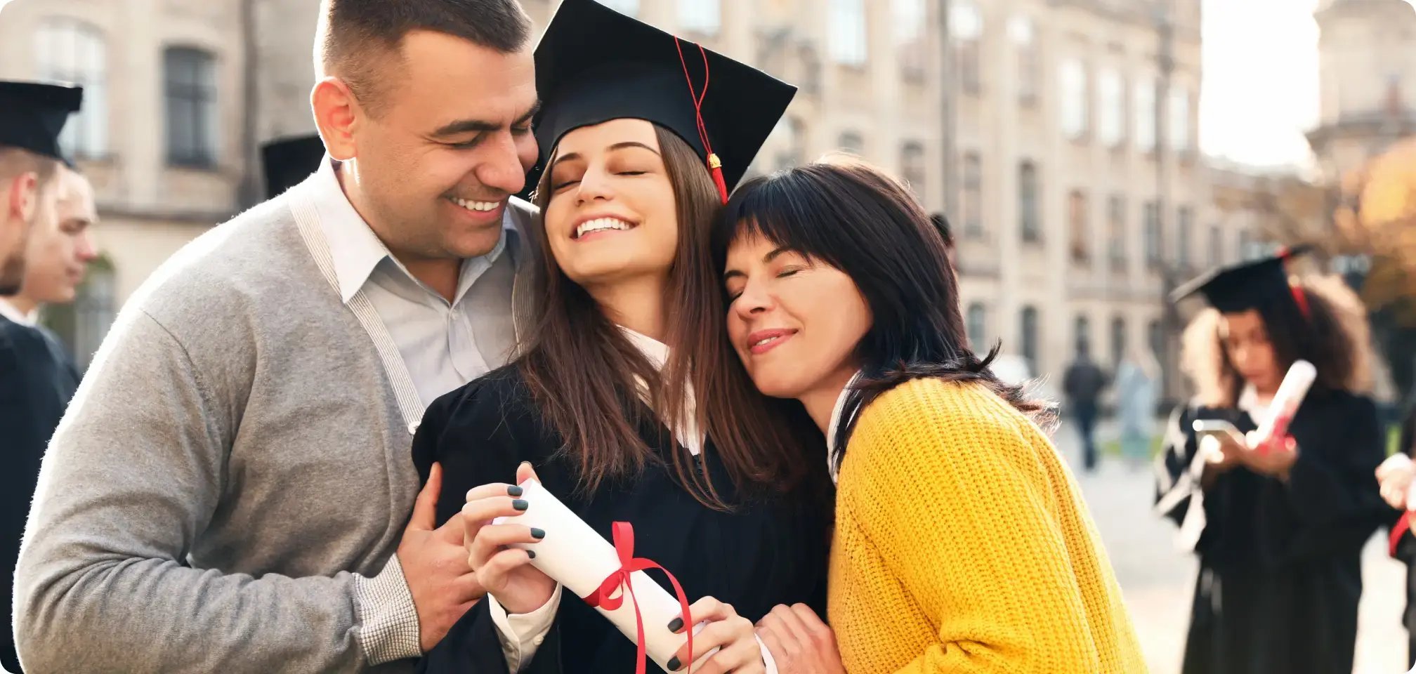 a student smiling with diploma in hand