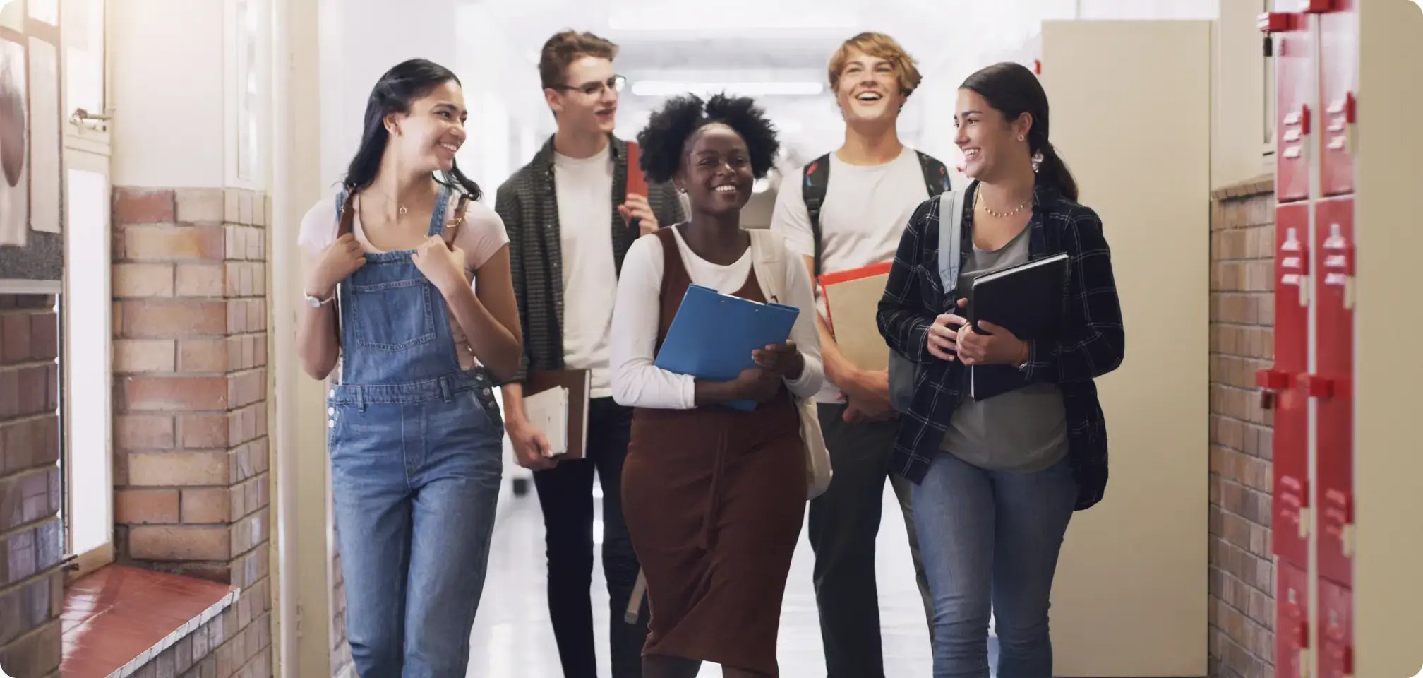 students smiling in the hallway