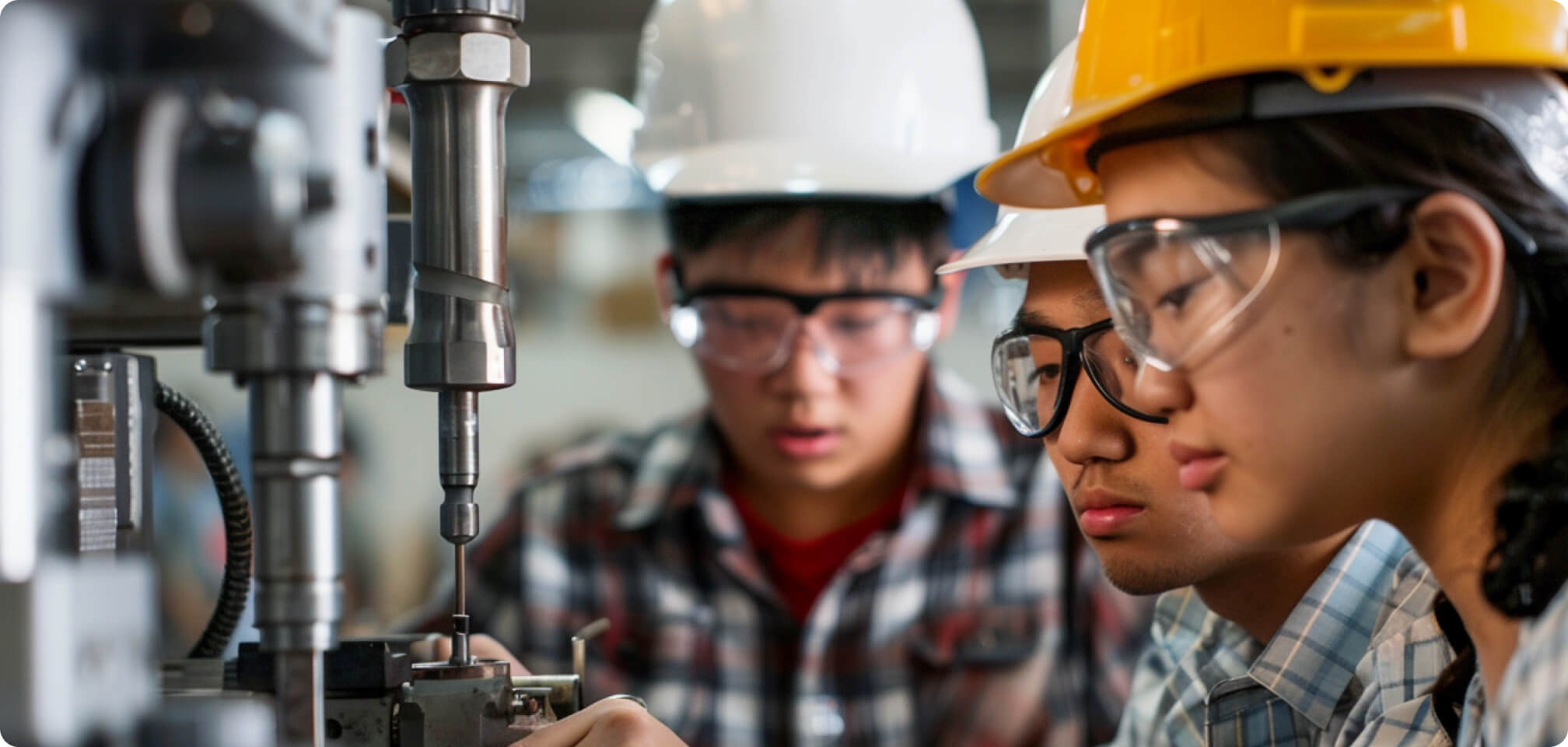 students in safety glasses operating some machinery