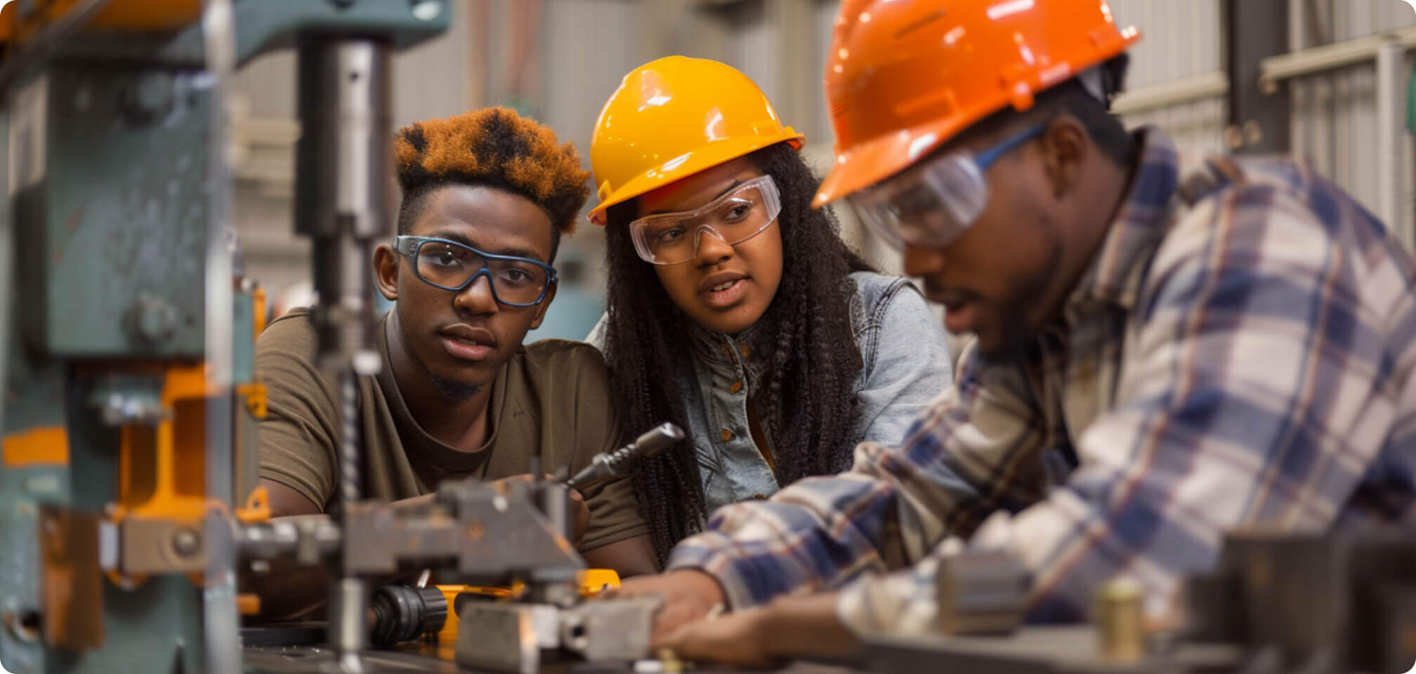 students in safety glasses operating some machinery