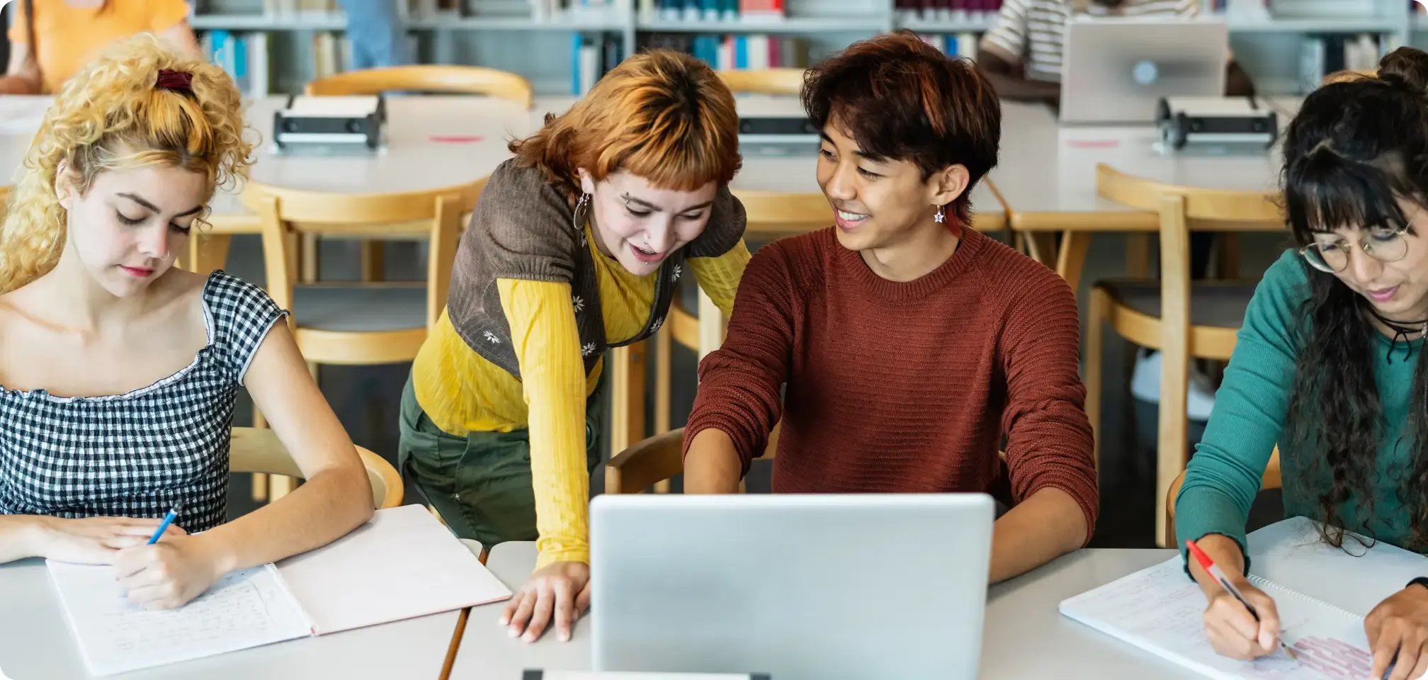 a student reading a textbook in class with others
