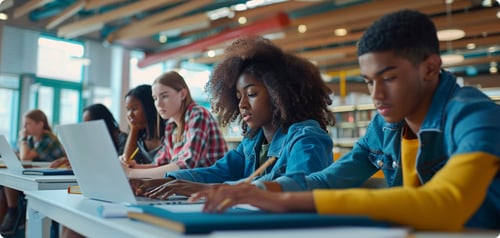 A diverse group of students all working at a desk together