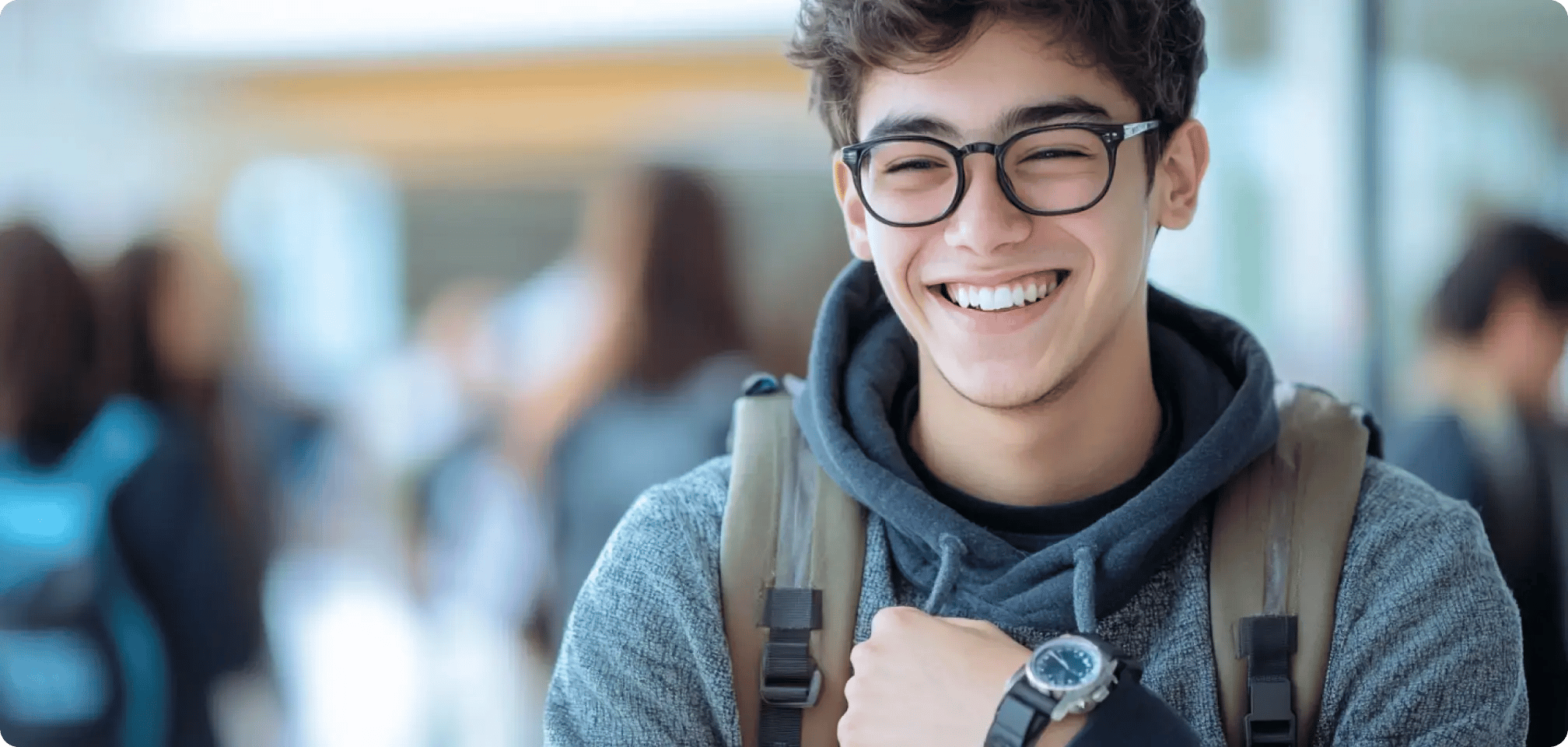 a student smiling looking at a clock or watch