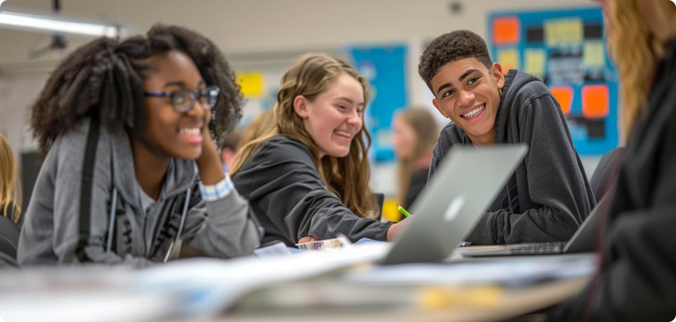 Image of a diverse group of students all working at a desk together