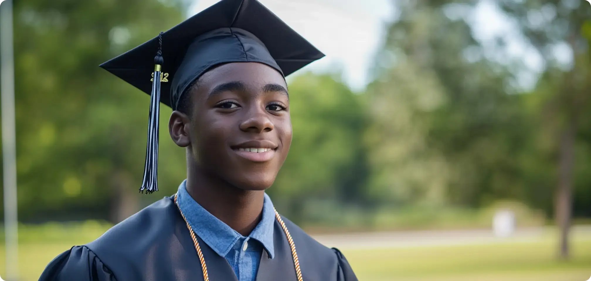 a student smiling in a graduation gown