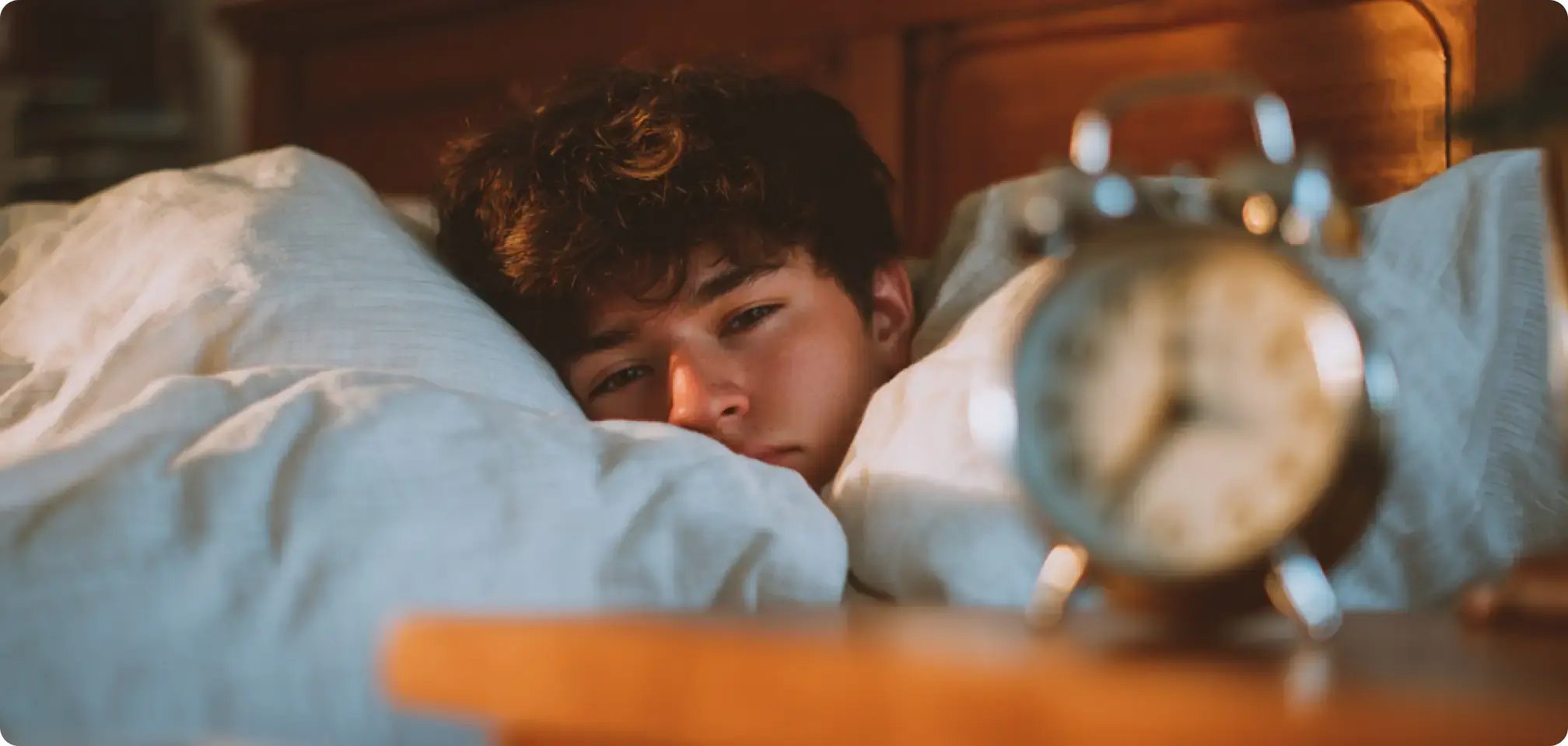 a student waking up to an alarm clock