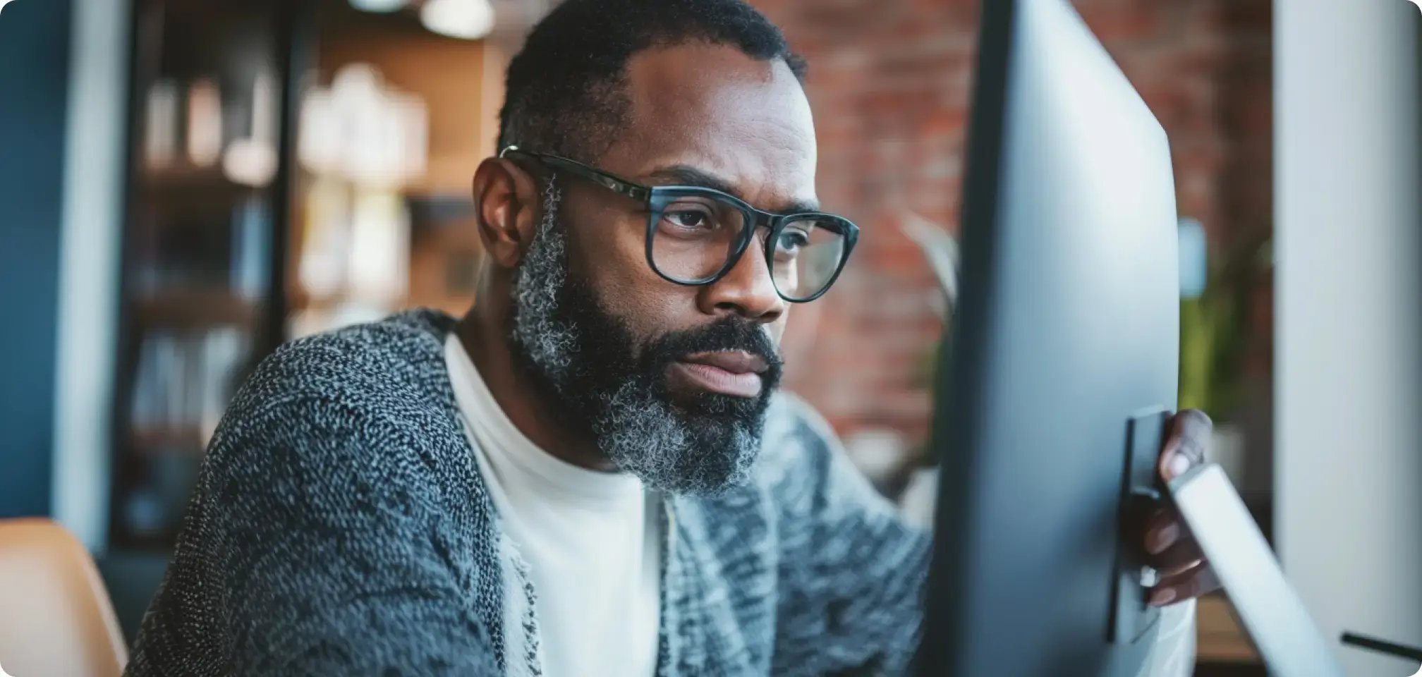 a parent looking at a computer with a curious look