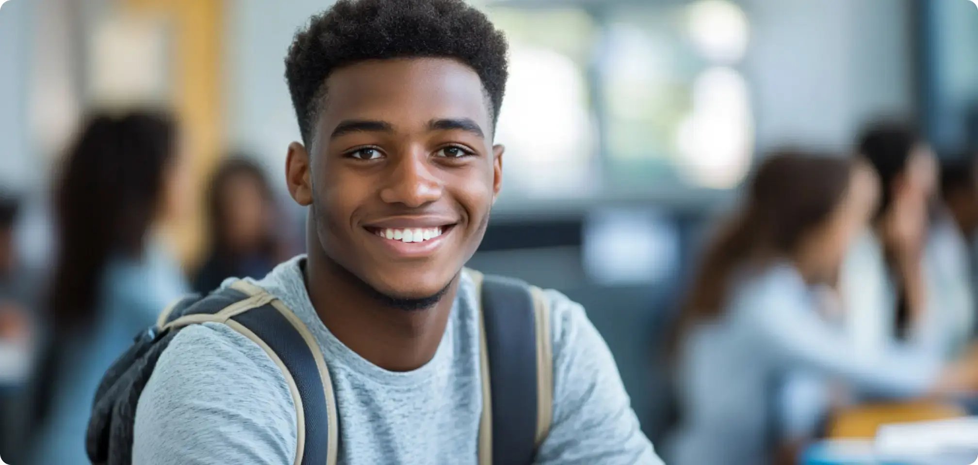 a student smiling with an A+ on assignment